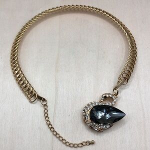 Statement style gold tone crystal swan cuff necklace